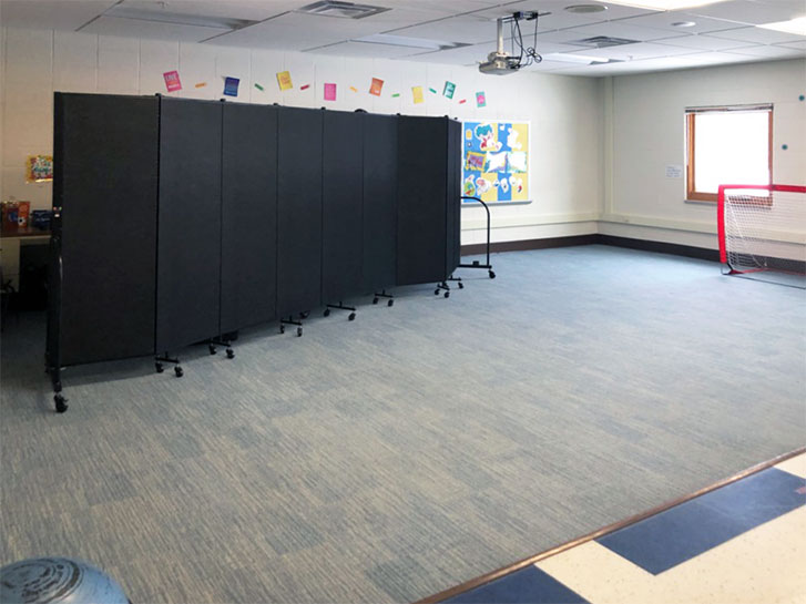 A room divider provides privacy in a therapy classroom