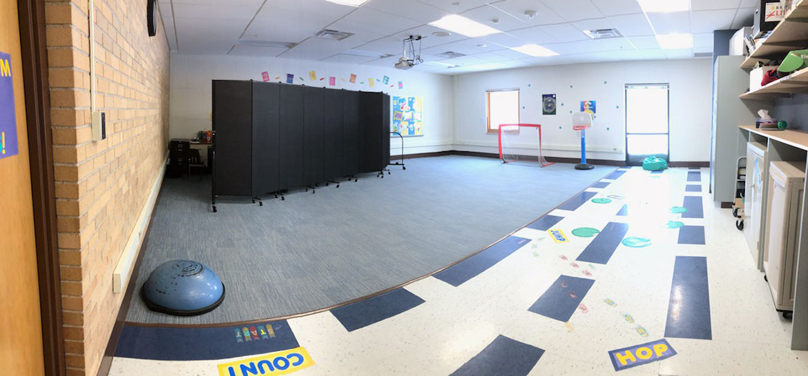 A classroom divider provides student privacy in a therapy classroom