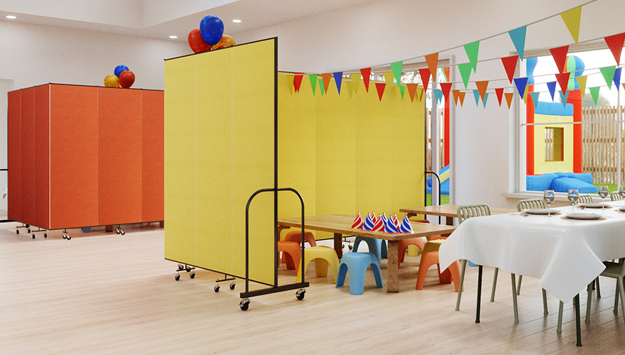 Yellow divider surrounding a small table and chairs of all colors