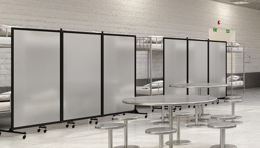 Correctional facility frosted dividers in front of beds