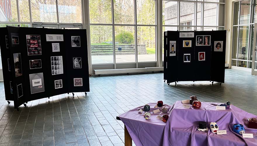 Student art displayed on black panels